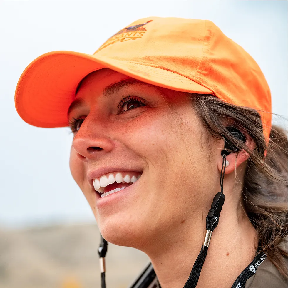 a woman in a hat wearing SoundGear Phantom hearing protection