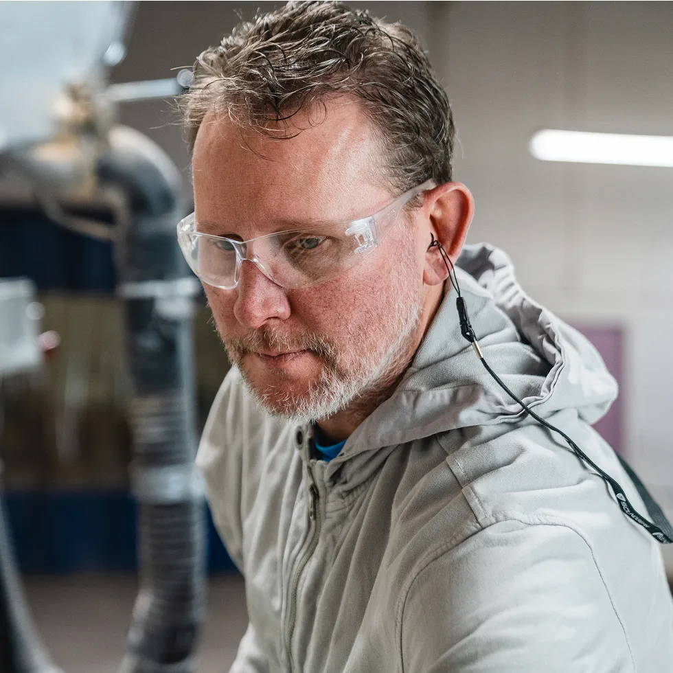 a man in safety glasses wearing SoundGear Shield hearing protection